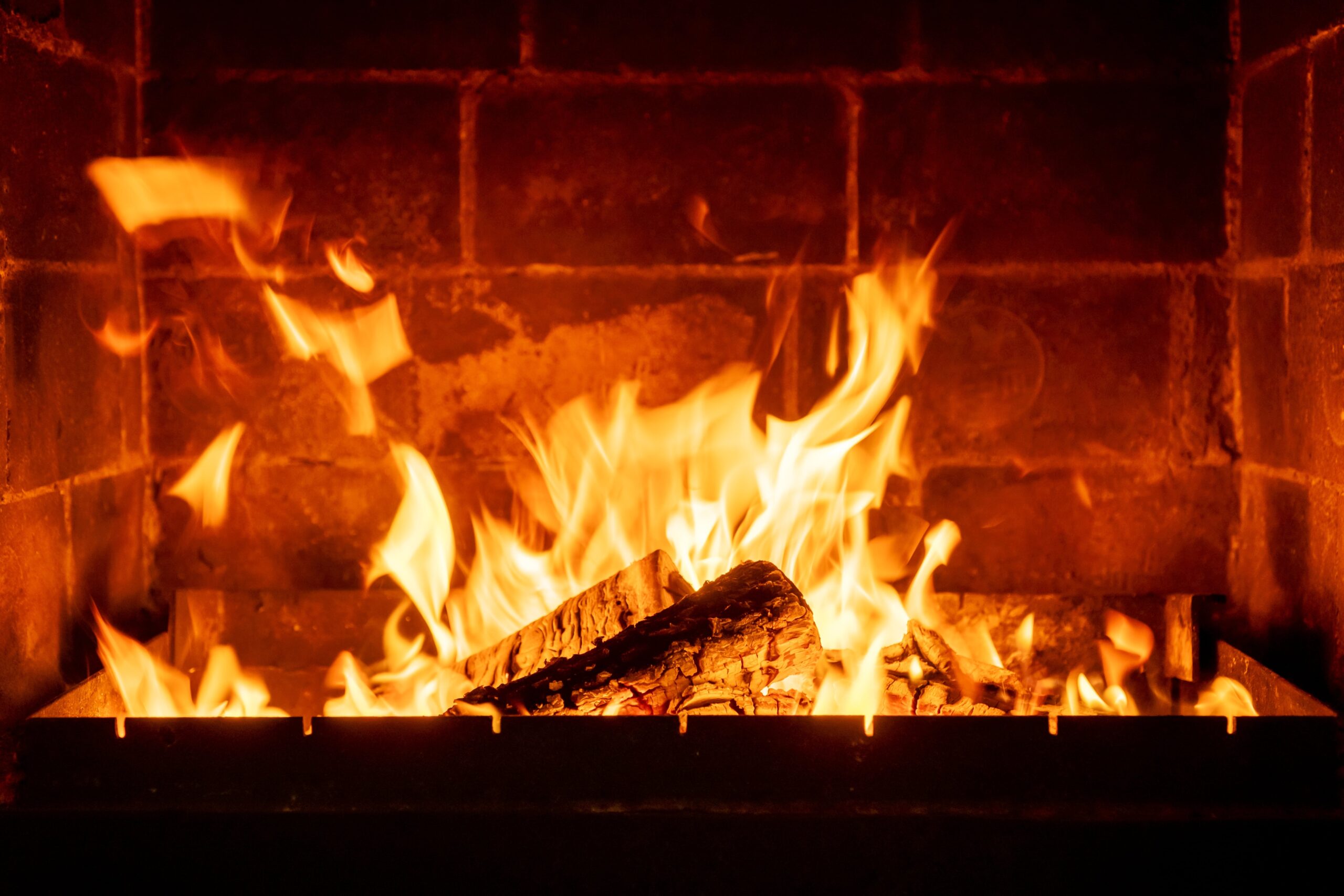 Burning wood and coal together in a multi-fuel stove for a warm, efficient fire with glowing flames and long-lasting heat.